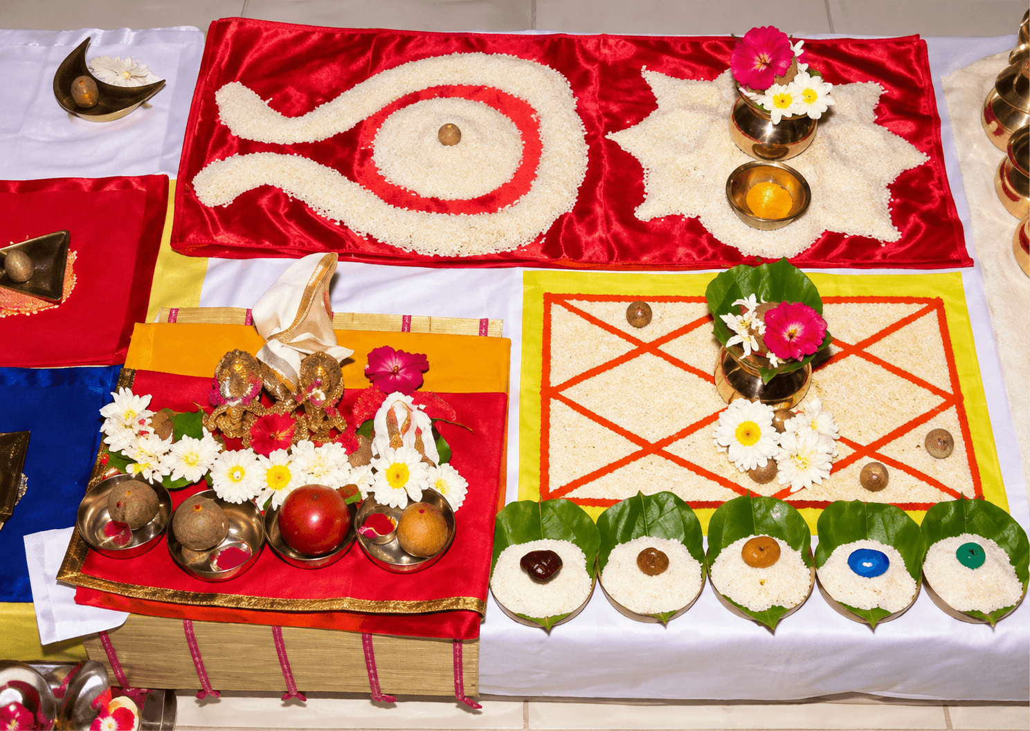 Offerings arranged on coloured cloth for a puja