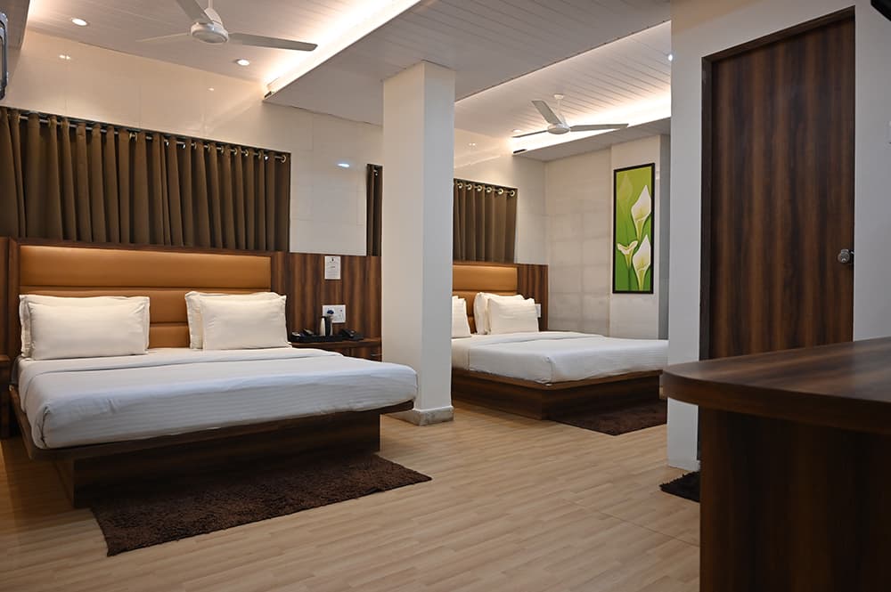Family room with two queen beds either side of a pillar